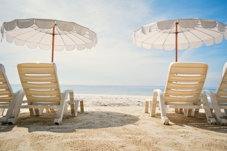 White chair with sun umbrella in the beach on seafront , relax time on vacationの写真素材