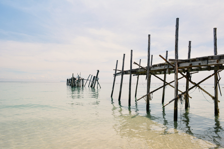 old wooden bridge in to the blue seaの写真素材