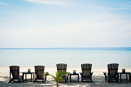Brown wood chair in the beach on seafront , relax time on vacationの写真素材