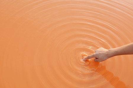Close up hand of girl and nature waterの写真素材