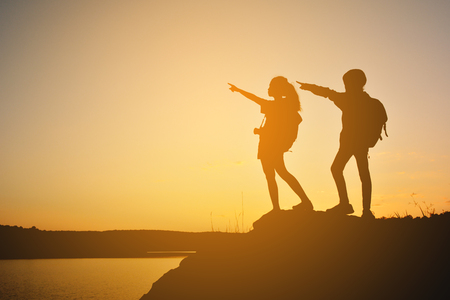 Silhouette women and girl backpacker on the top mountain , Relax time travel on holidayの写真素材