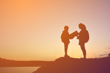 Silhouette women and girl backpacker on the top mountain , Relax time travel on holidayの写真素材