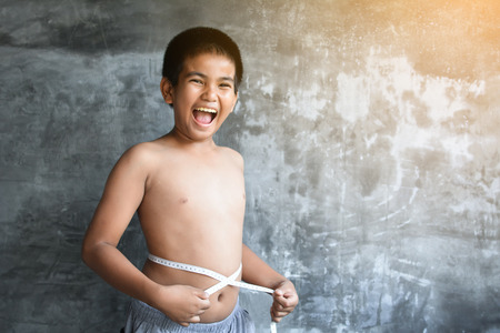 Portrait Asian fat boy concept healthy and lose weight ,selective and soft focusの写真素材