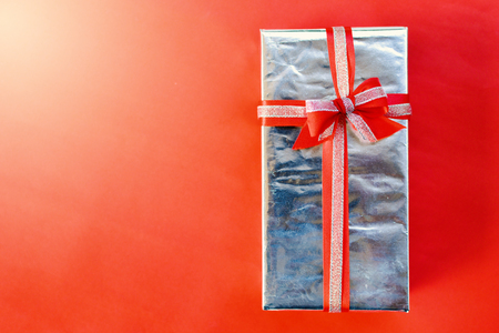 Gift box on red background for Christmas conceptの写真素材
