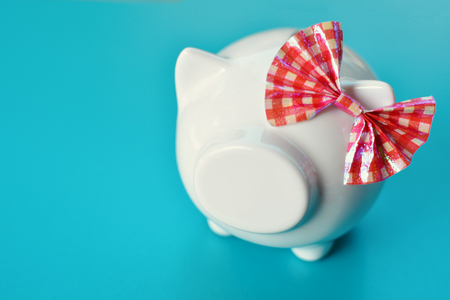 White piggy bank on blue background concept save moneyの写真素材