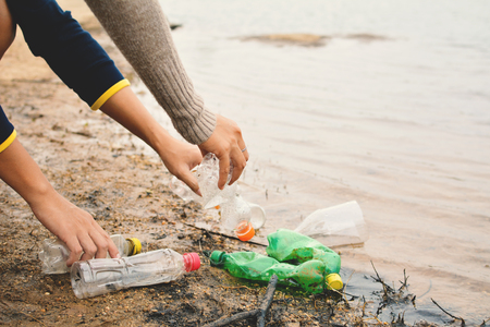 Hand of people picking up empty of bottle plastic ,volunteer conceptの写真素材