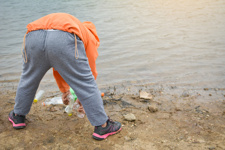 Boy picking up empty of bottle plastic ,volunteer conceptの写真素材