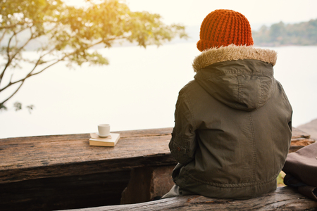 Asian boy sitting on park winter season, Relax time on holiday ,selective and soft focus,tone of hipster styleの写真素材