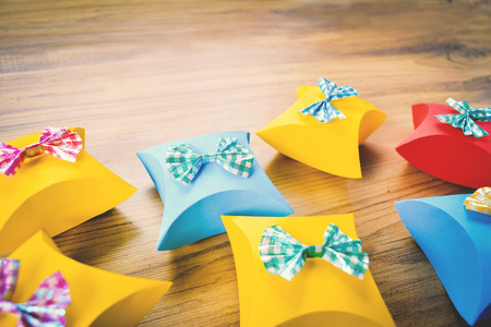 Colorful gift box paper on brown wood, Christmas and New year concept,selective and soft focusの写真素材