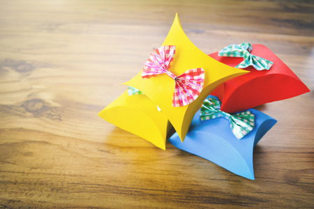 Colorful gift box paper on brown wood, Christmas and New year concept,selective and soft focusの写真素材