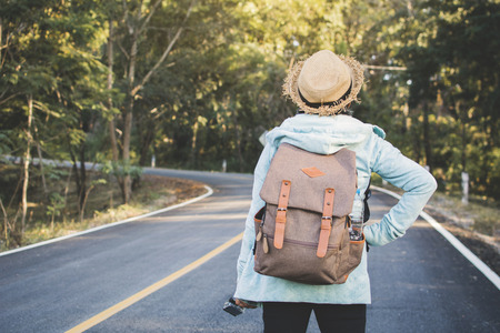 Happy hipster old women backpack traveling on the road relax time and holiday, color vintage style selective and soft focusの写真素材
