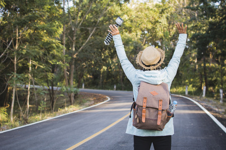 Happy hipster old women backpack traveling on the road relax time and holiday, color vintage style selective and soft focusの写真素材