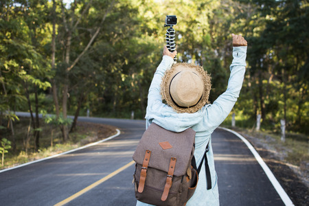 Happy hipster old women backpack traveling on the road relax time and holiday, color vintage style selective and soft focusの写真素材