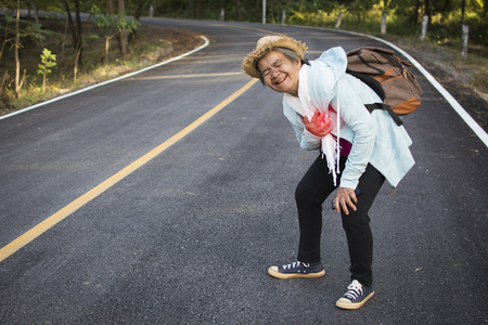 Old women heart ache during backpack traveling on the road , color vintage style selective and soft focusの写真素材