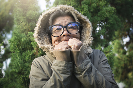 Happy hipster old women tourist feels cold on holiday, color vintage style selective and soft focusの写真素材