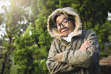 Happy hipster old women tourist feels cold on holiday, color vintage style selective and soft focusの写真素材