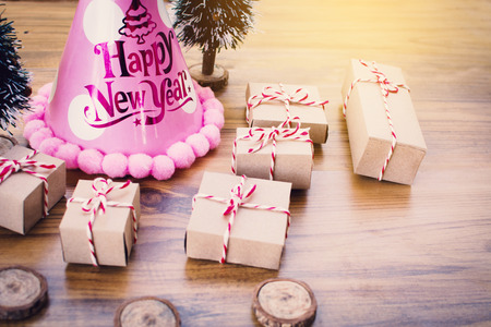 Paper gift box with pine tree accessory on brown wood, Merry Christmas and Happy New year concept,selective and soft focusの写真素材