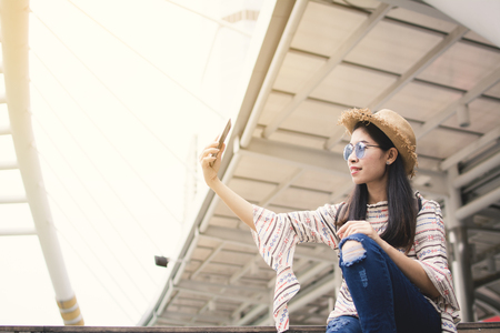Asian woman tourist using smartphone selfie during travel in Bangkok, Relax time on vacation hipster lifeの写真素材