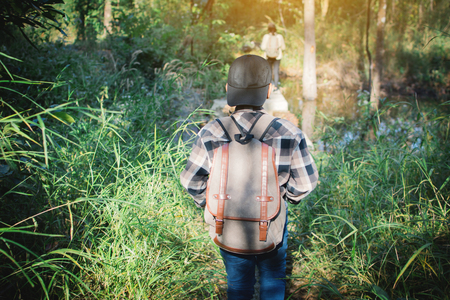 Asian children walking in forest , Relax time on holiday , concept backpacker hipster styleの写真素材