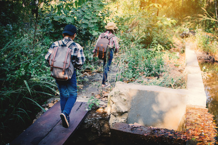 Asian children walking in forest , Relax time on holiday , concept backpacker hipster styleの写真素材