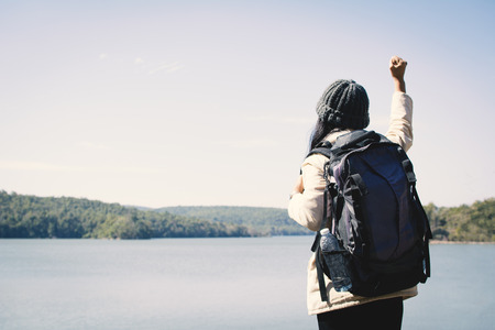 Happy Asian woman backpacker in nature winter season,Relax time on holiday concept travel,selective and soft focus,tone of hipster styleの写真素材