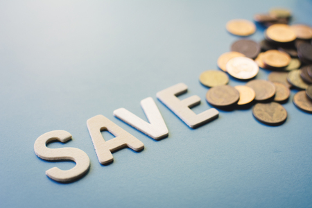 Save word with coins on blue backgroundの写真素材