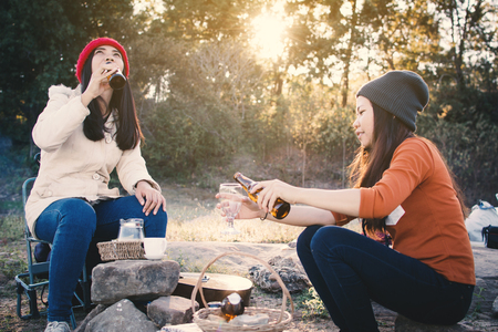 Happy Asian woman camping in nature winter season,Relax time on holiday concept travel,selective and soft focus,tone of hipster styleの写真素材