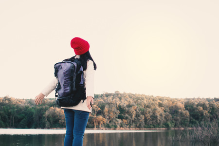 Happy Asian woman backpacker in nature winter season,Relax time on holiday concept travel,selective and soft focus,tone of hipster styleの写真素材