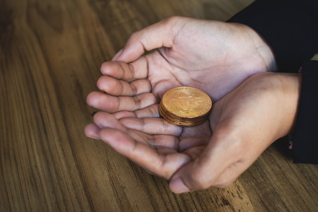 Businesswoman holding bitcoin, color of vintage tone