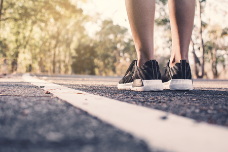 Feet women running on the road for health, color of vintage tone selective and soft focusの写真素材