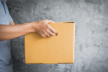 Delivery man sending box from online shopping serviceの写真素材