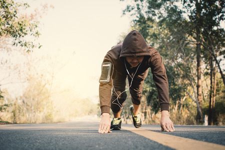 Man doing exercise on the road for health, color of vintage tone selective and soft focusの写真素材