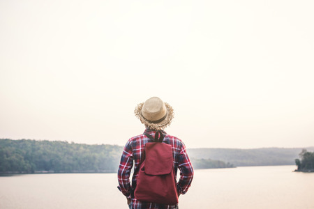 Relaxing moment Asian boy backpacker in nature ,enjoying time on holiday concept ,color of vintage...