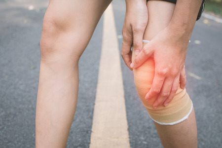 Woman accident during running on the road , color of vintage tone selective and soft focusの写真素材