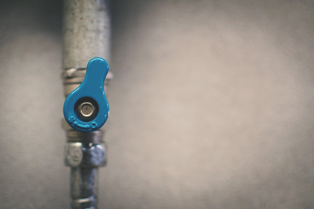 Close-up faucet on the vintage wall background