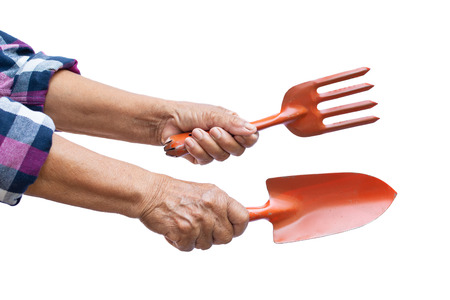 Farmer hand holding shoveling on a white backgroundの写真素材