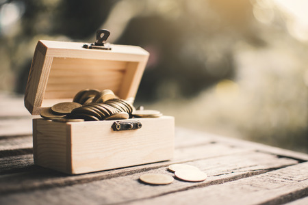 Coins in wood box, color vintage style selective and soft focus.の写真素材