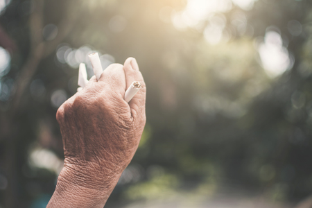 Old hand crushing cigarettes, Stop smoking concept.の写真素材