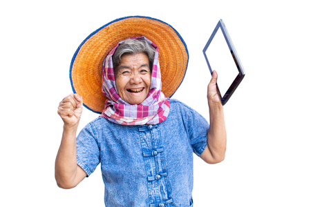 Happy old women farmer using tablet and joyful on a white backgroundの写真素材
