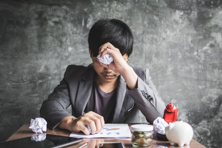 Young man anxiety about work and business in office.の写真素材