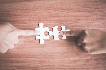 Business people holding jigsaw connection and success conceptの写真素材