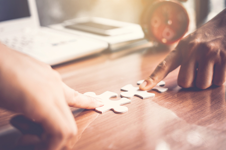 Business people holding jigsaw connection and success conceptの写真素材