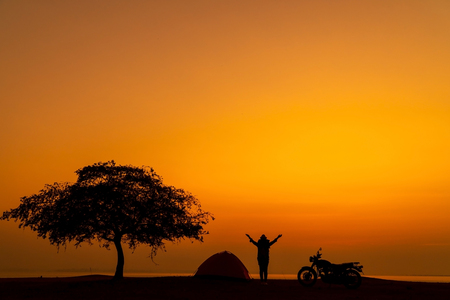 Silhouette of woman relax time with wonderful day for resting and vacation.の写真素材