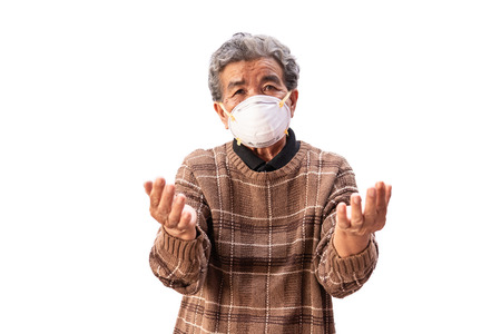 Old woman wearing a mask fear problem air pollution on a white background, healthcare concept.の写真素材