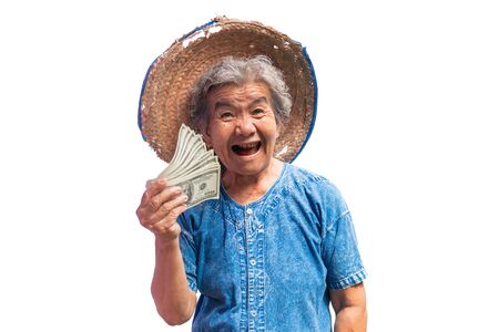 Happy old farmer woman holding a money on a white background.の写真素材