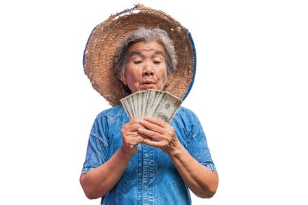 Happy old farmer woman holding a money on a white background.の写真素材