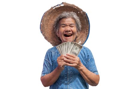 Happy old farmer woman holding a money on a white background.の写真素材