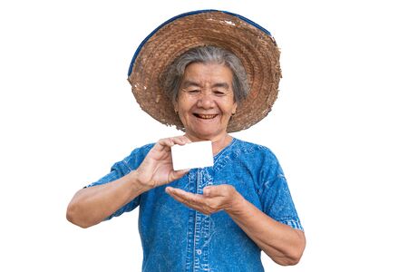 Happy old farmer woman holding a smart card on a white background.の写真素材