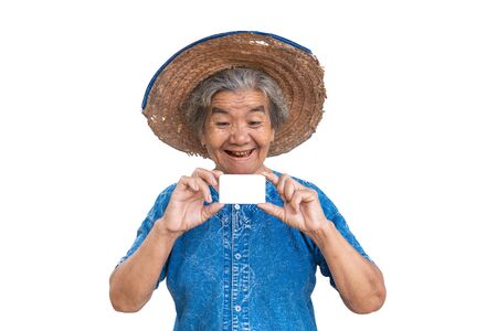 Happy old farmer woman holding a smart card on a white background.の写真素材
