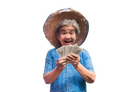 Happy old farmer woman holding a money on a white background.の写真素材